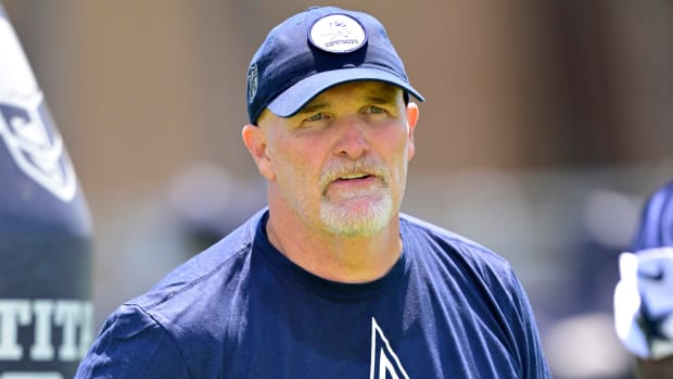 Dallas Cowboys offensive coordinator Dan Quinn watches over training camp drills.